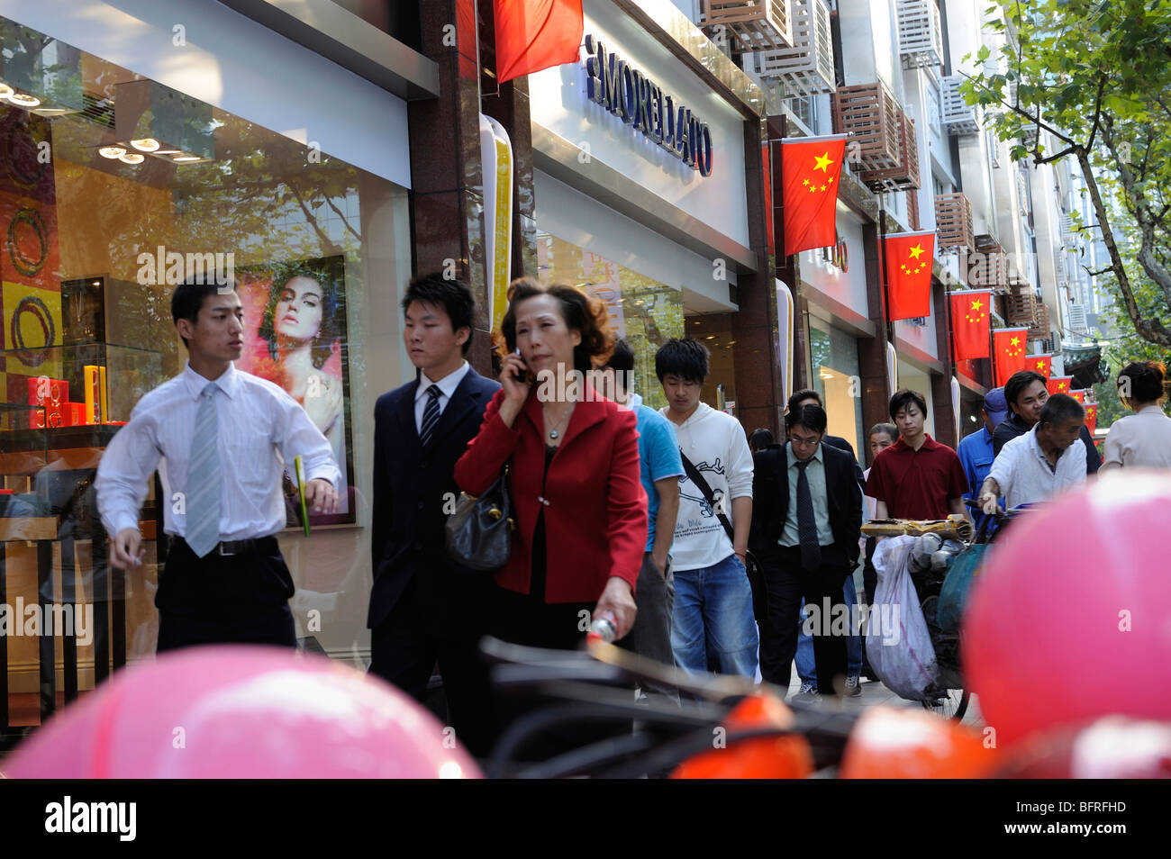 Business people in a hurry on Nanjing Road West, Shanghai, China.10-Oct-2009 Stock Photo