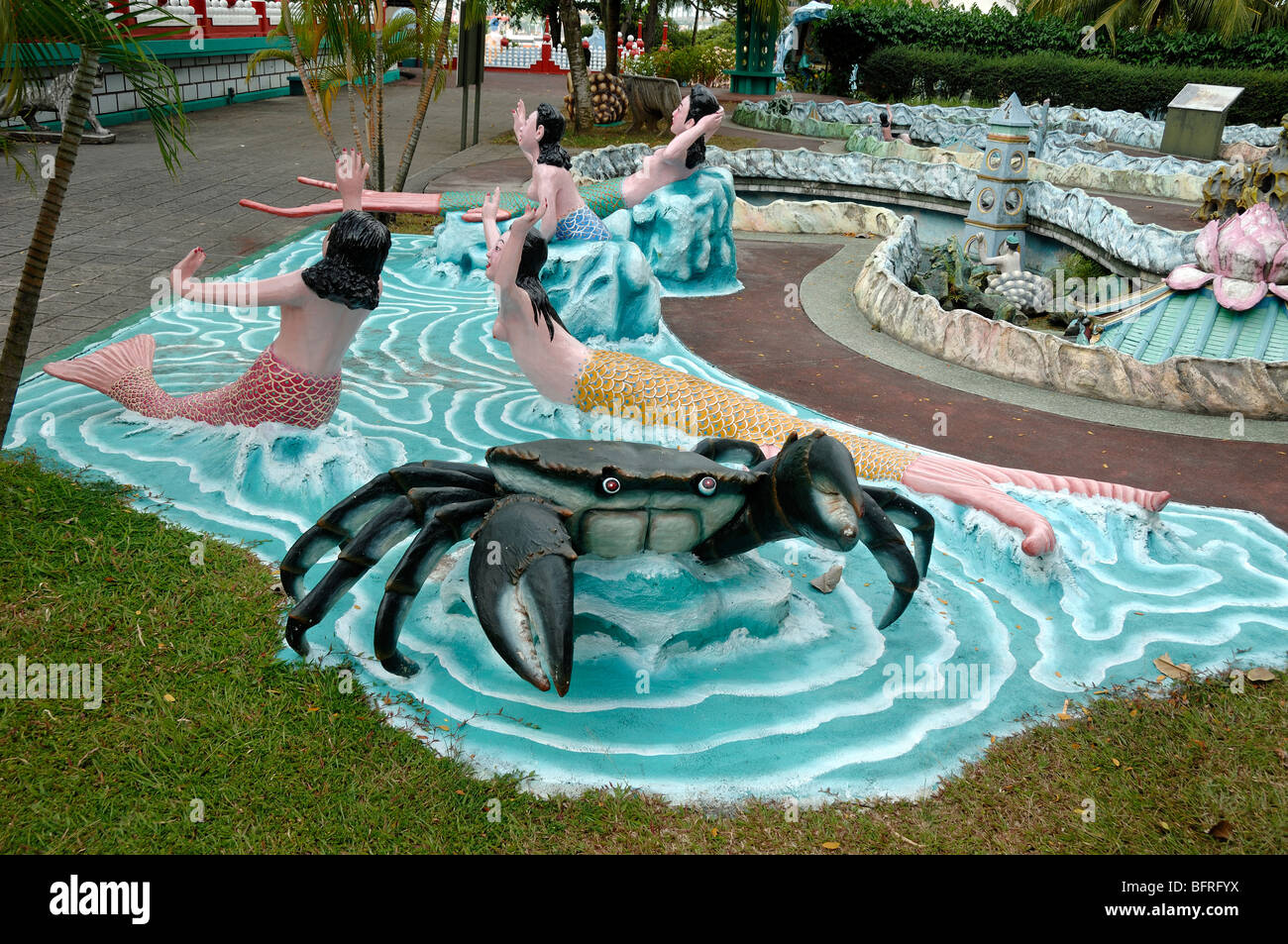 Giant Crab and Mermaids or Mermaid Satues in the Signature Pond, Tiger Balm Gardens Chinese Theme Park, Singapore Stock Photo