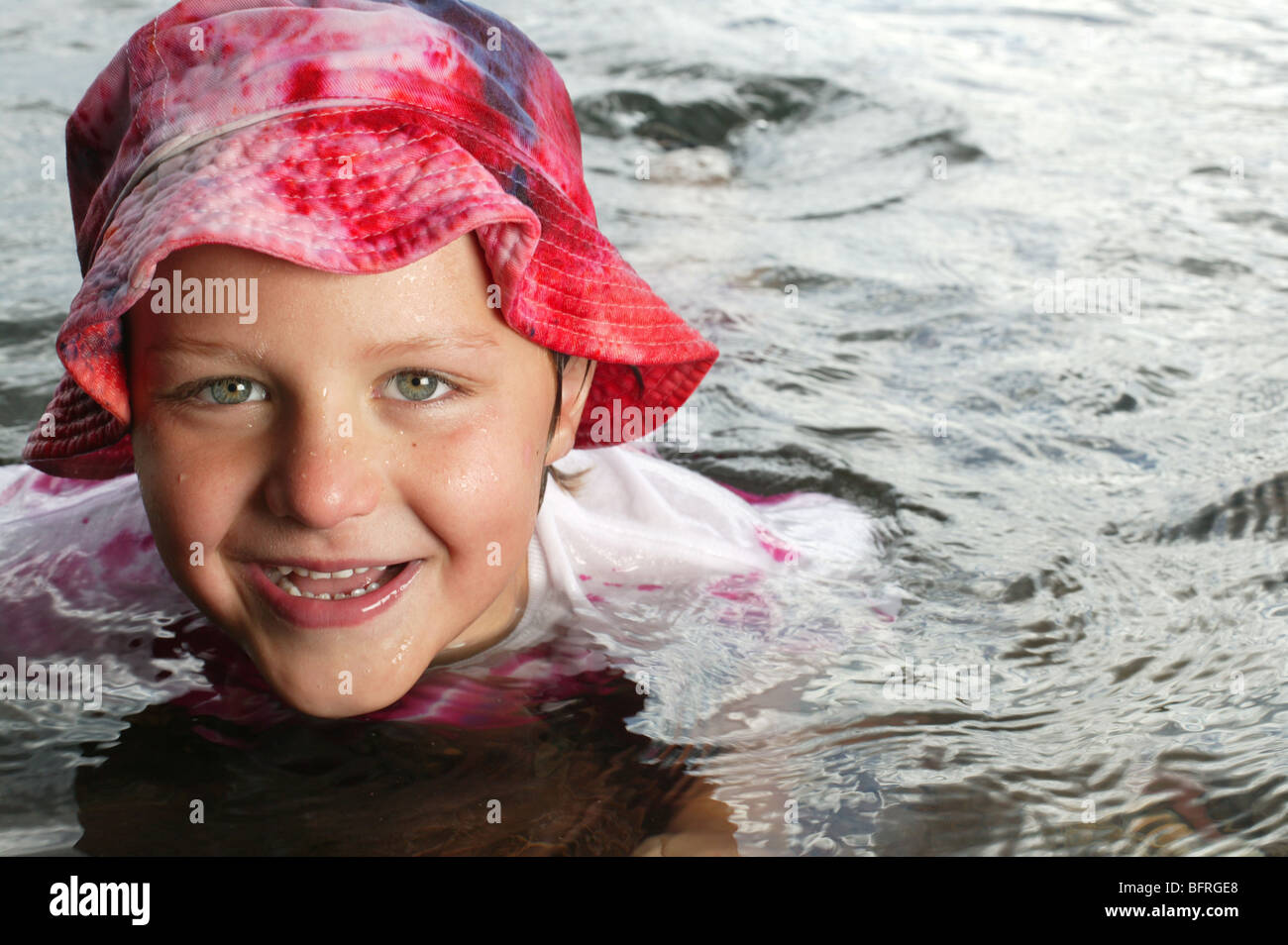boy with hat in water- Stock Photo