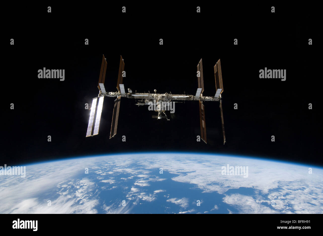 International Space Station backdropped by Earth's horizon. Stock Photo