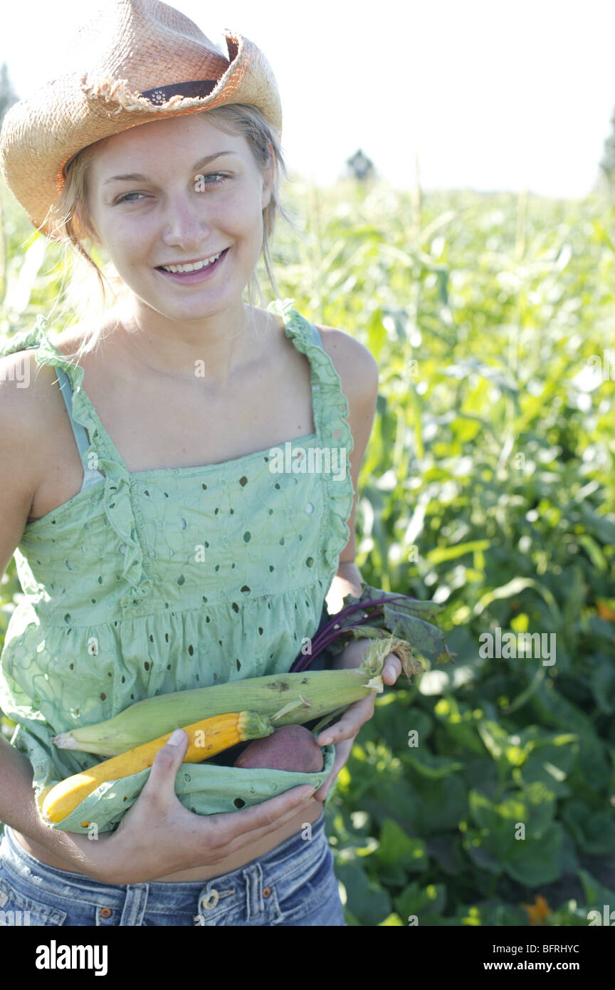 teen with vegetables at organic garden Stock Photo