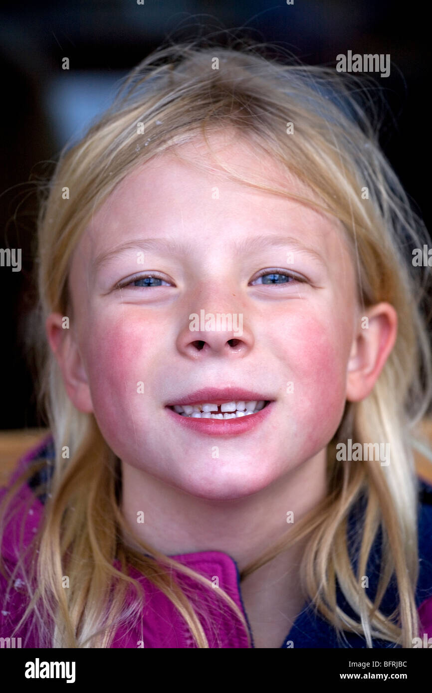 A pale, rosy cheeked six year old girl making faces. Stock Photo