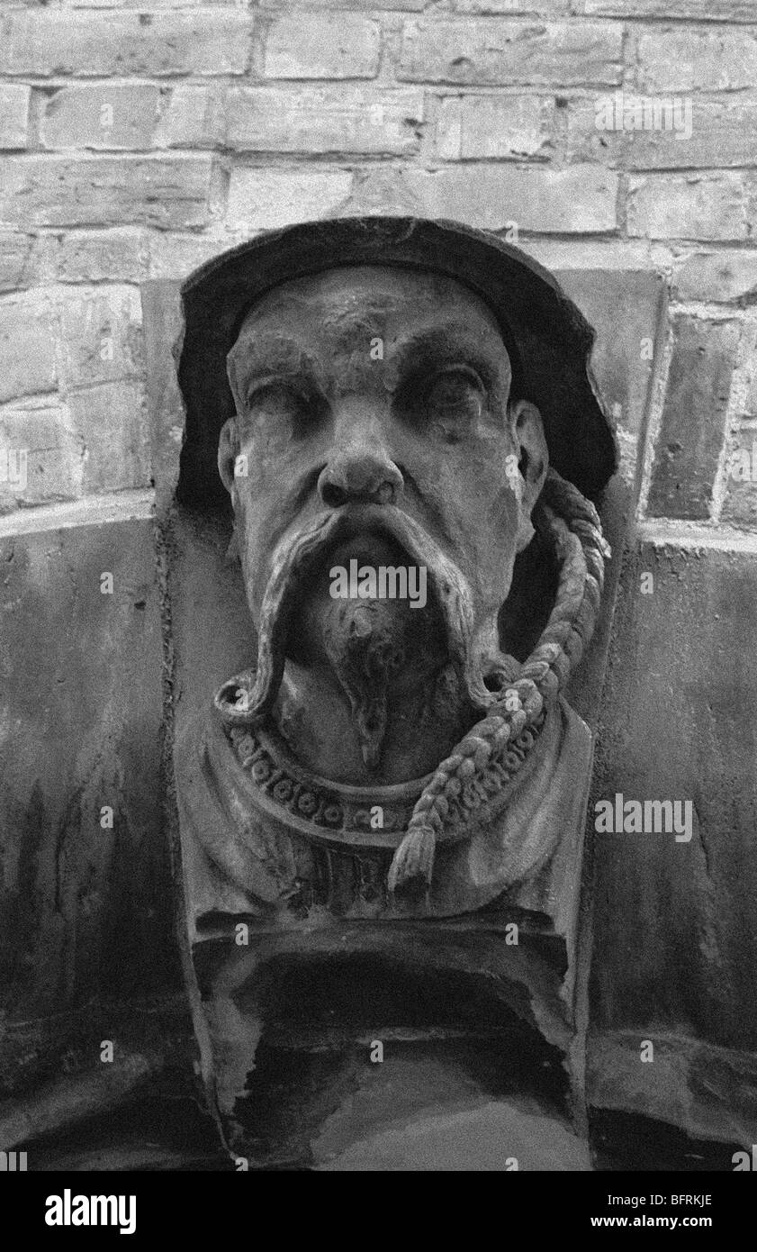 Stonework head carving of a gargoyle sailer located on the side of the Masmoulin hotel Belfast. Stock Photo