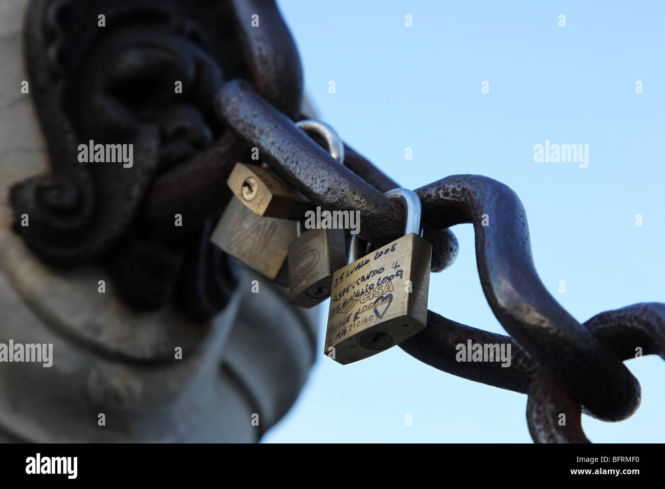 Lovers attach padlocks, to symbolise their unbreakable love in front of Michelangelo's David in Florence, Italy. Stock Photo