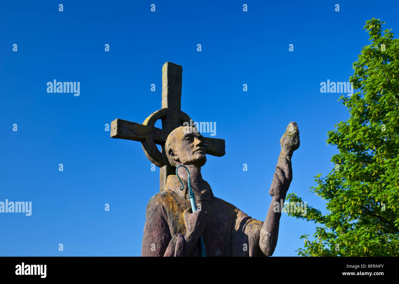 The iconic holy statue of St Aiden on a warm summers day with deep blue skies. Stock Photo