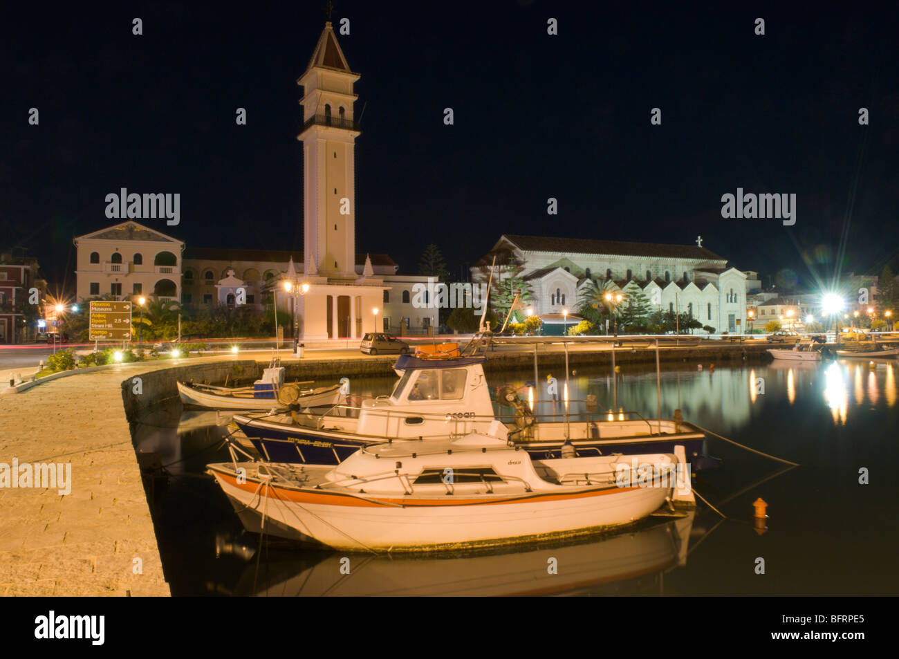 Greece. Zakynthos. Zante. Greek island. October. The Church of Agios Dionysios seen across the harbour in Zakinthos Town. Dusk. Stock Photo