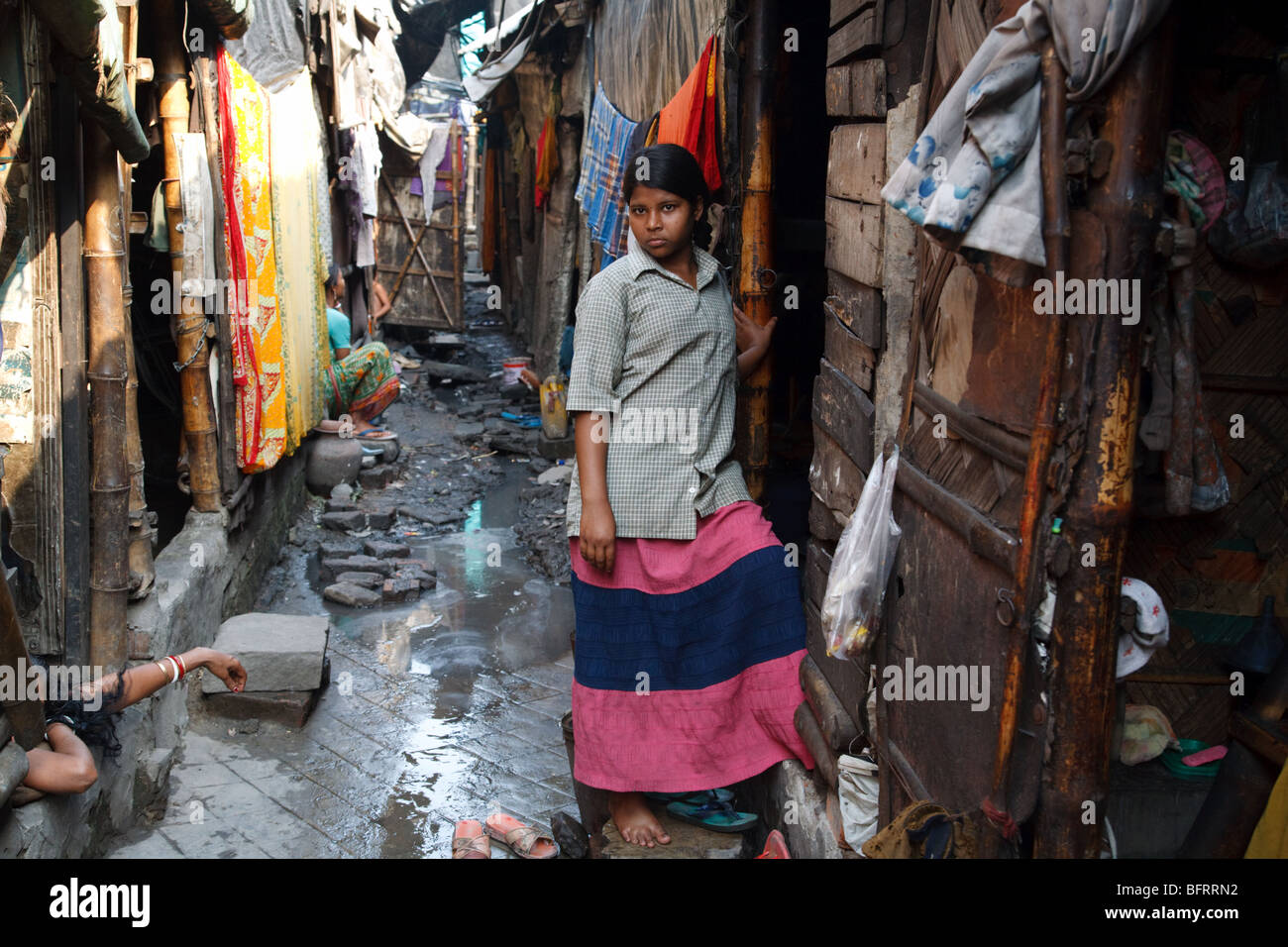 A wyoung woam at her hut doorstep in one of the slums in Kolkata, India Stock Photo