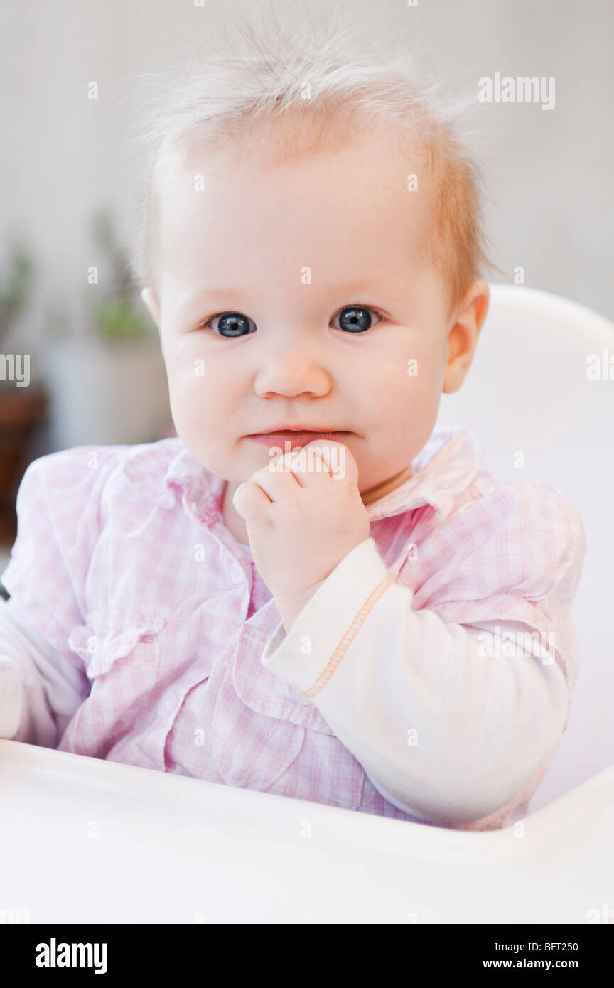 Baby Girl in High Chair Stock Photo Alamy