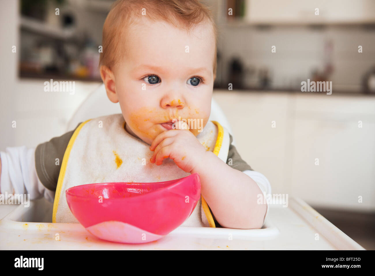 Baby in High Chair Eating Stock Photo Alamy