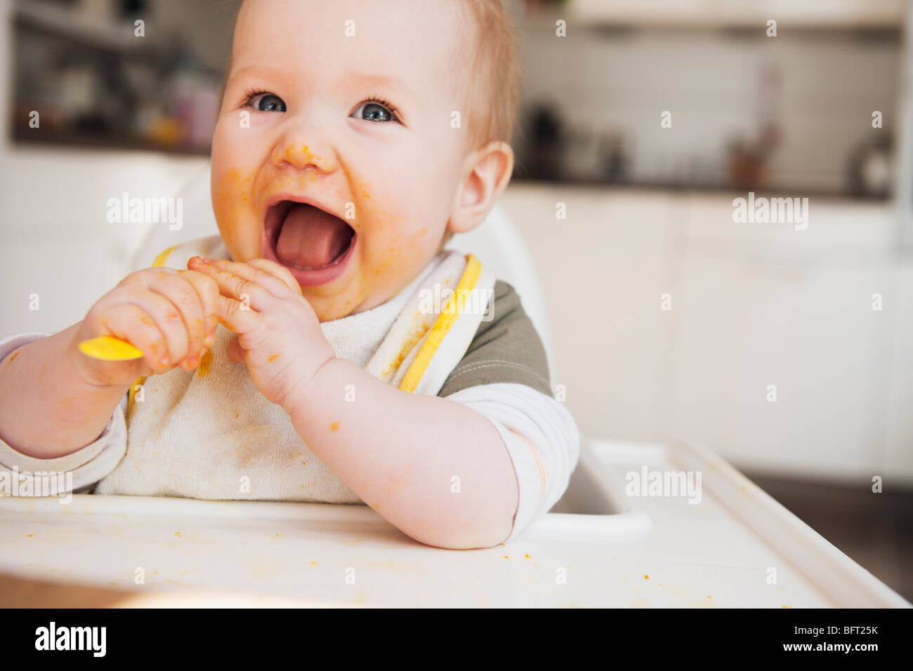 Baby in High Chair Eating Stock Photo Alamy