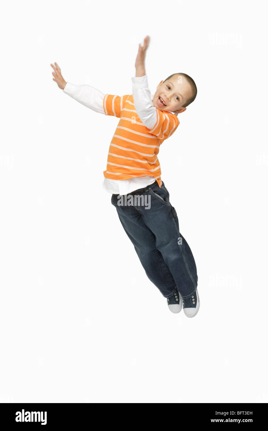 Boy Jumping in Studio Stock Photo