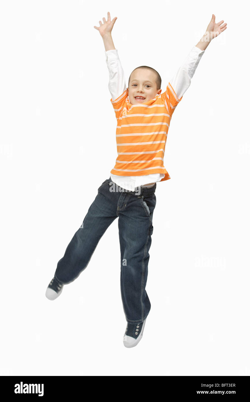 Boy Jumping in Studio Stock Photo