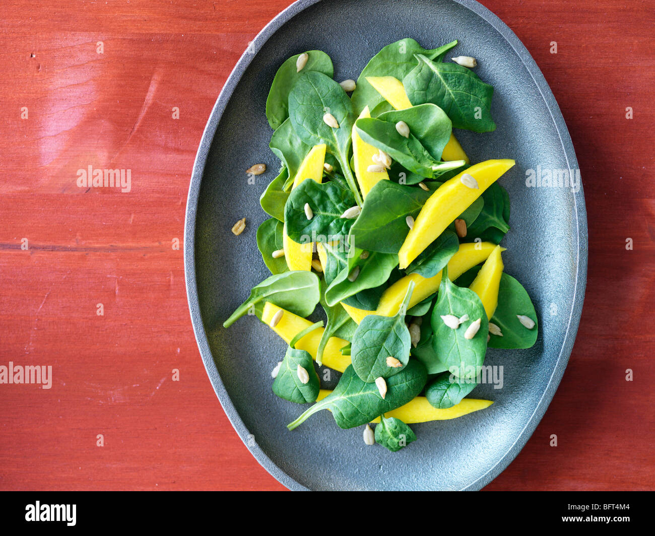 Spinach Salad with Mango and Sesame Seeds Stock Photo