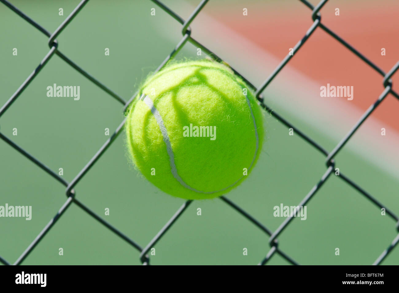 Tennis Ball Stuck in Chain Link Fence Stock Photo Alamy
