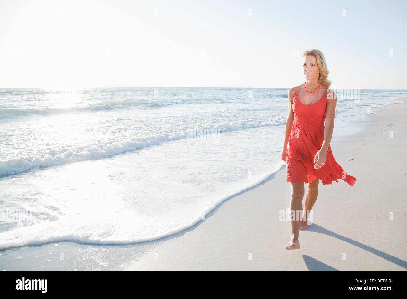 Beach mature woman enjoy sun hi-res stock photography and images - Alamy