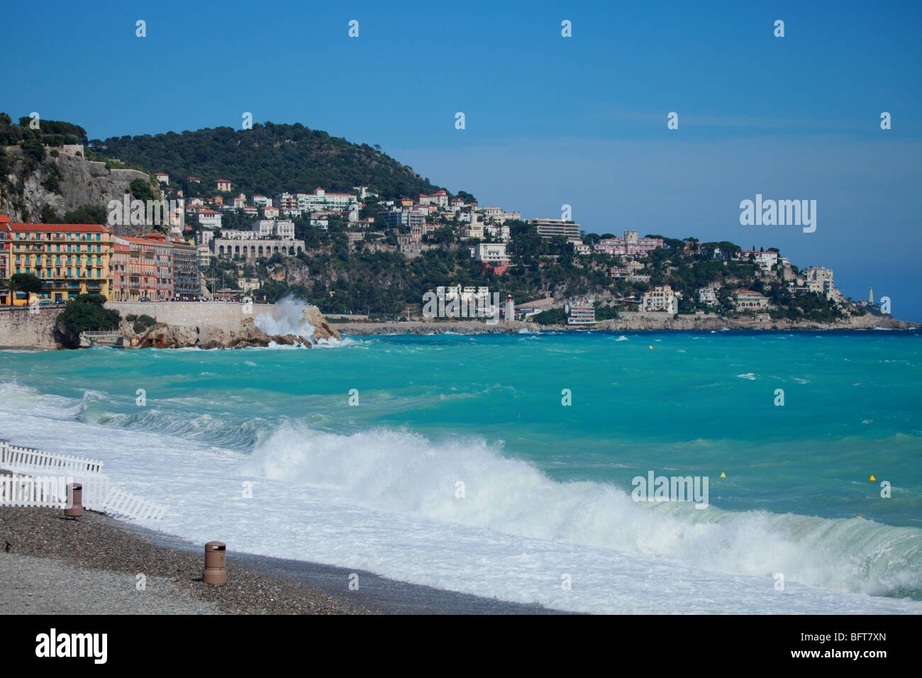 Rough sea on the beach and the Mont Boron with the cape of Nice in the background Stock Photo