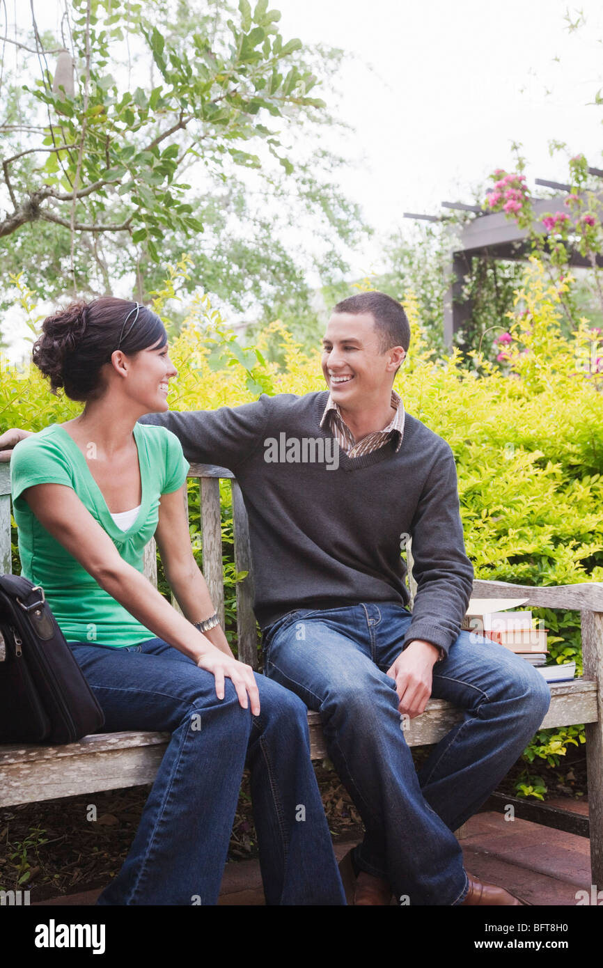 University Students Sitting Together on a Bench Stock Photo