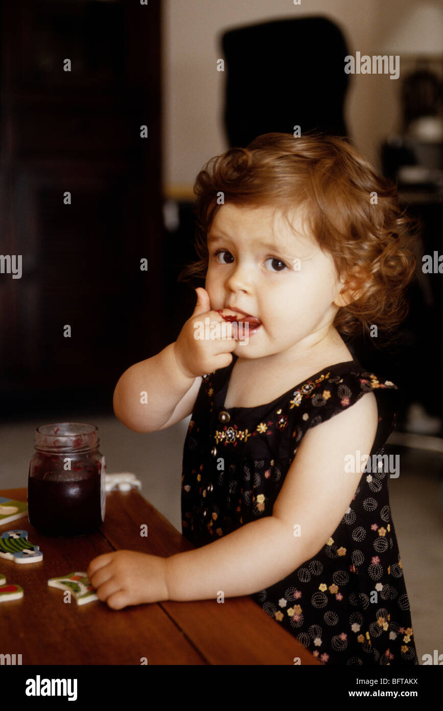 Faustine 16 months old eating jam Stock Photo Alamy