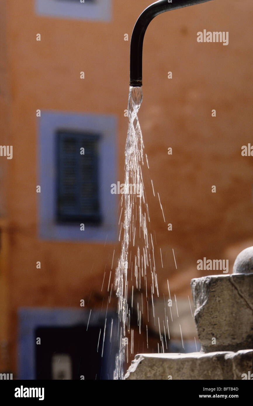 Water jet from the fountain of Sospel. Village located 5 miles away from Menton and the mediterranean coast. Stock Photo