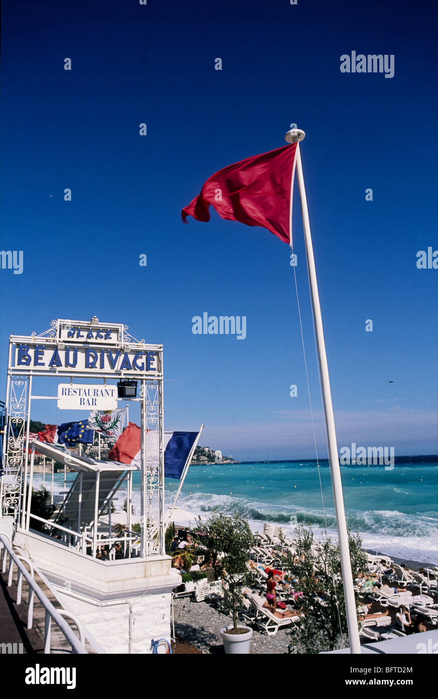 Red flag because of rough sea on the beach of Nice Stock Photo