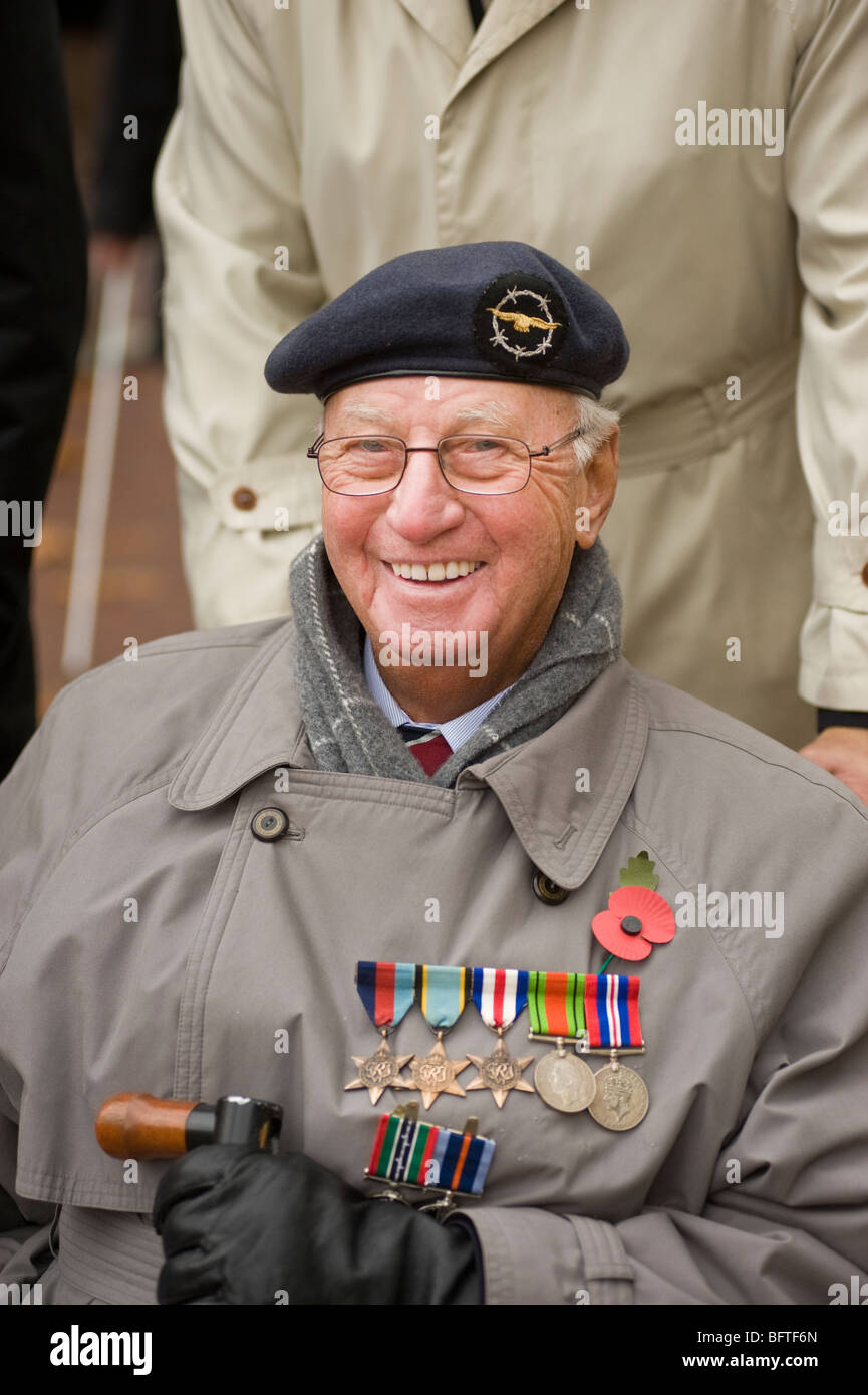 A disabled war veteran in a wheelchair wearing his campaign war medals smiling on Remembrance Day Parade in Central London, UK Stock Photo