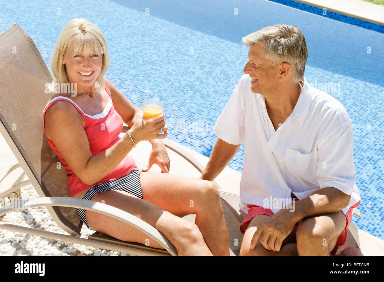 A senior couple by the pool Stock Photo - Alamy