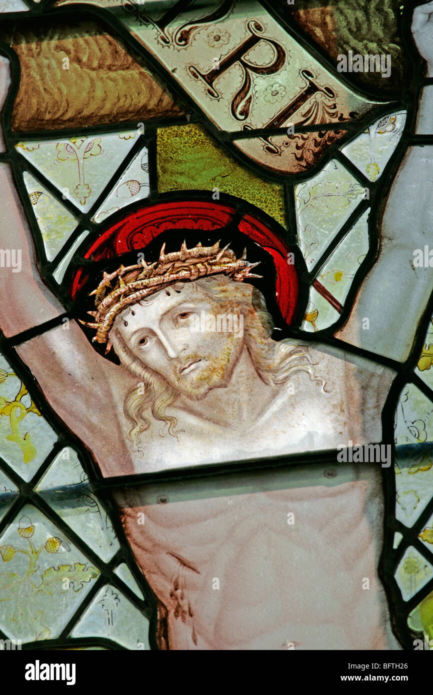 Detail of a stained glass window depicting Jesus on the cross, by Charles Eamer Kempe, Stratford Tony, Wiltshire Stock Photo