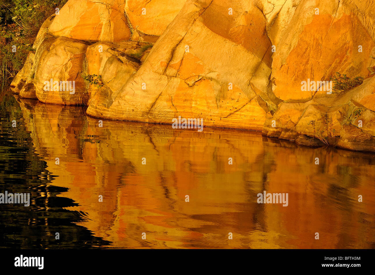Granite cliff reflected in George Lake, Killarney Provincial Park, Ontario, Canada Stock Photo
