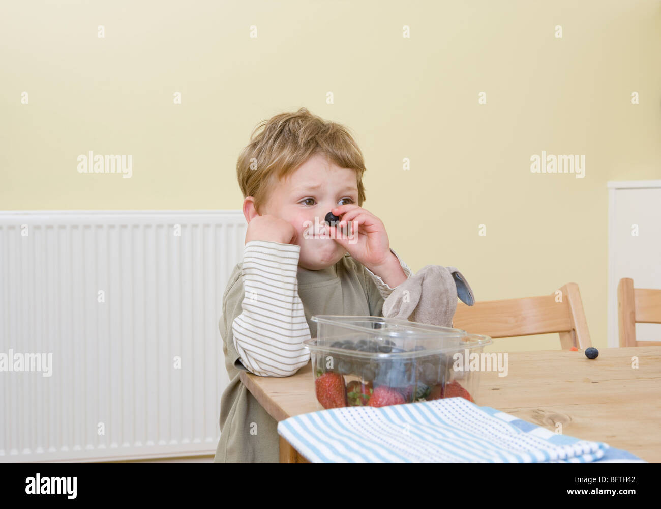 Child holding nose and eating hires stock photography and images Alamy