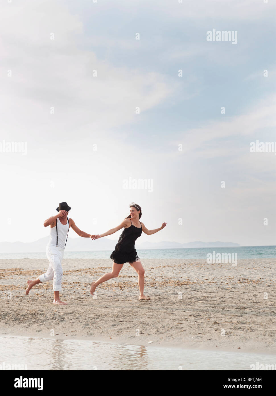 couple running on the beach Stock Photo