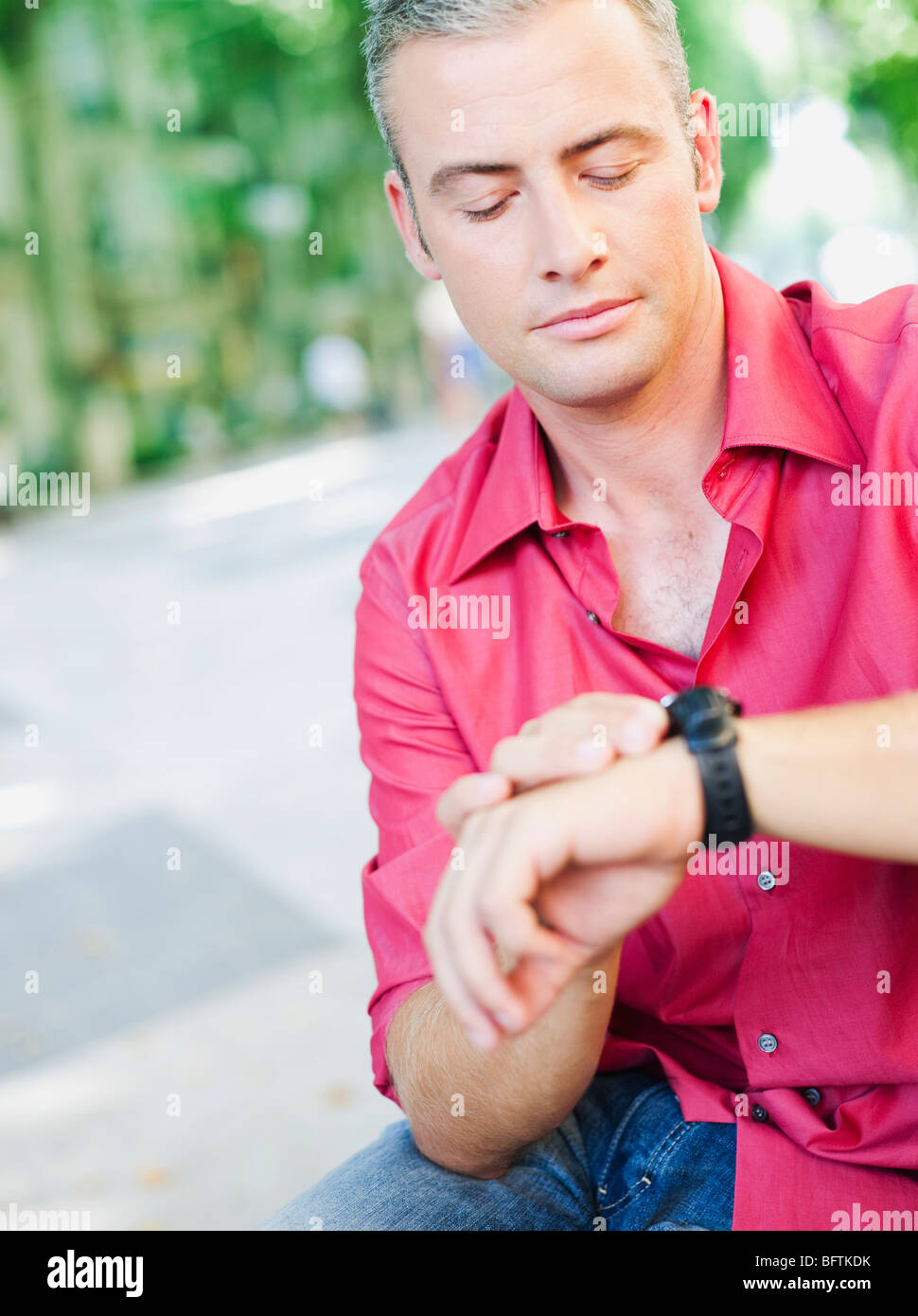 man looking at his watch Stock Photo - Alamy