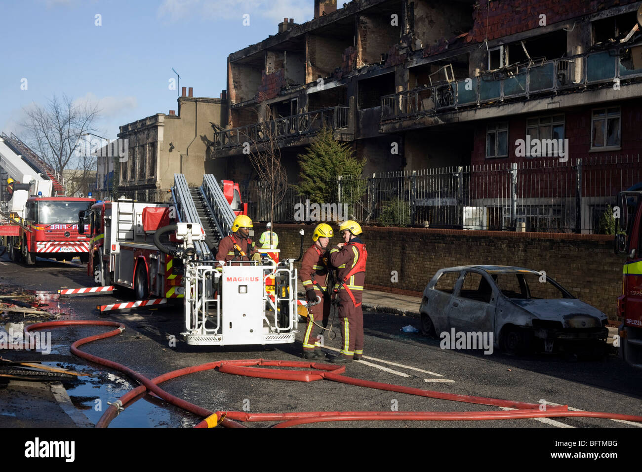 Fire fighters in the aftermath of an innercity estate fire in south London Stock Photo Alamy