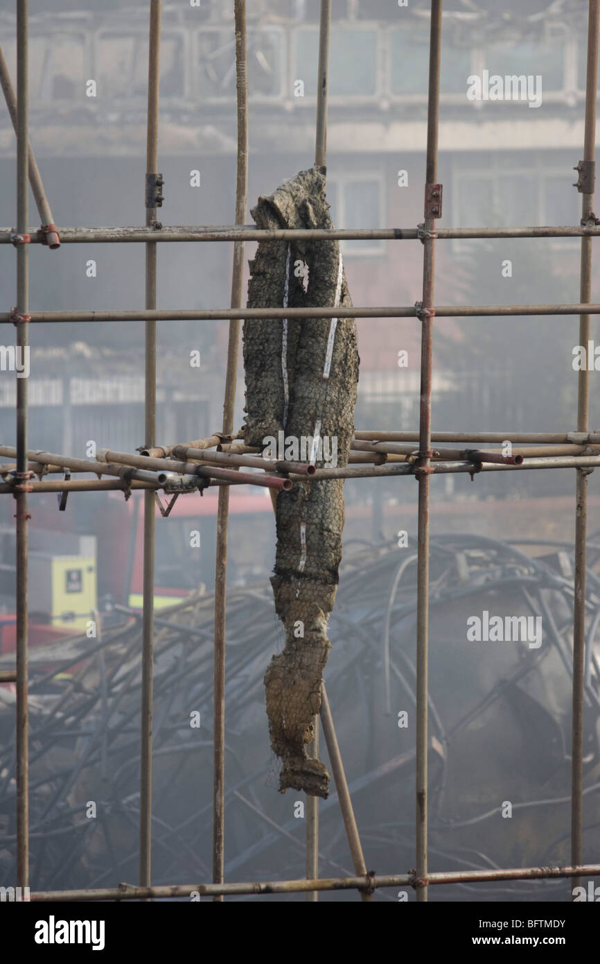 Smouldering remains of a construction site after an inner-city estate fire in south London. Stock Photo