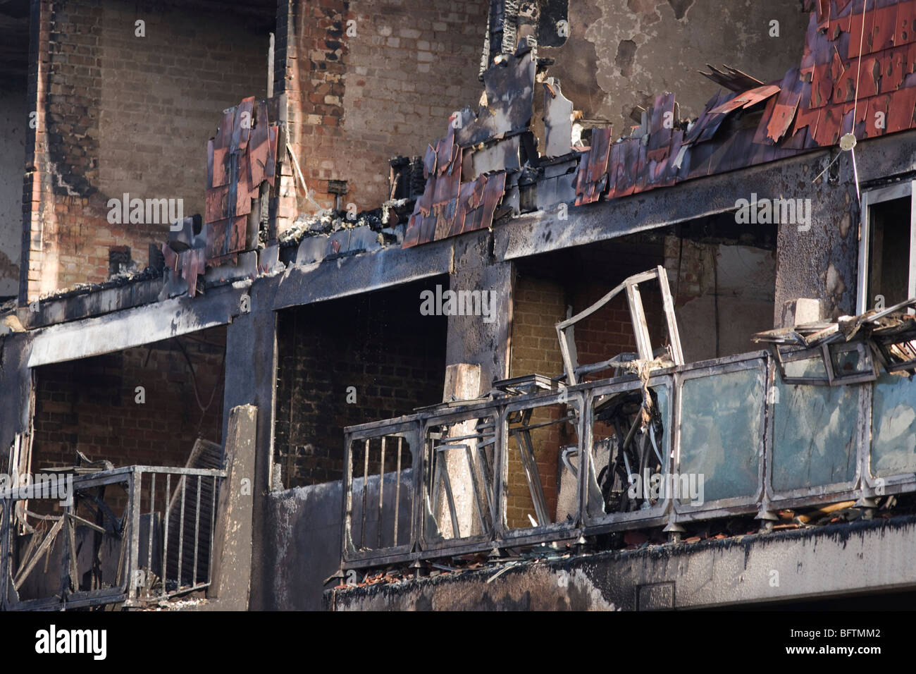 Melted properties and devastated frontages after an inner-city estate fire in south London. Stock Photo