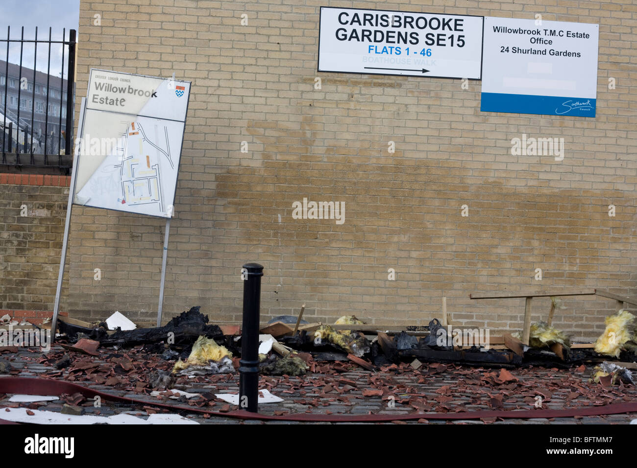 Roofing debris lies on the pavement from nearby flats after an inner-city fire in London. Stock Photo