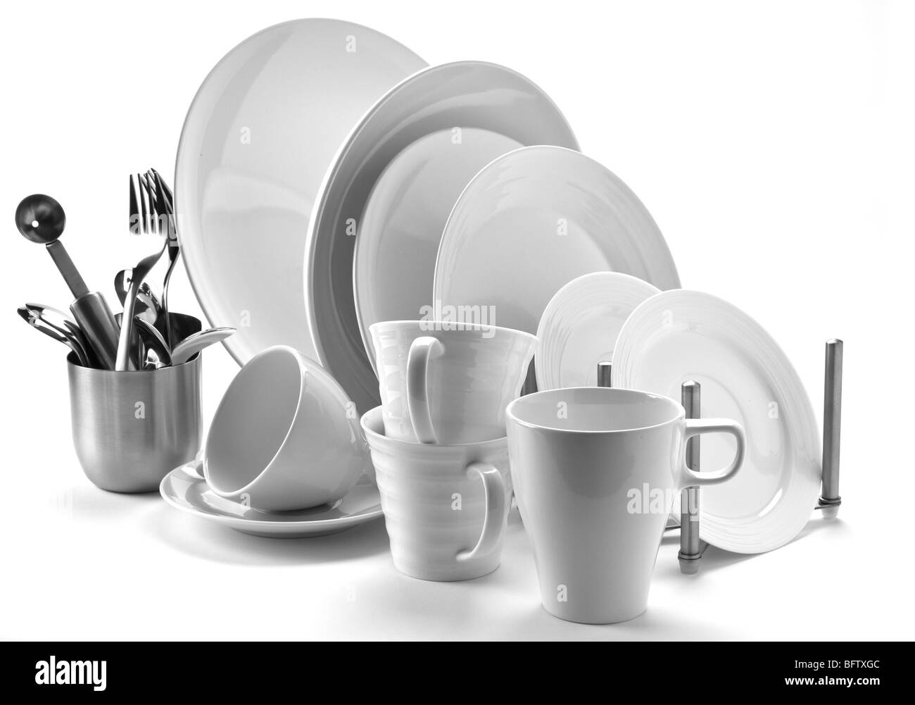 set of fresh washed plates and cutlery isolated on white Stock Photo