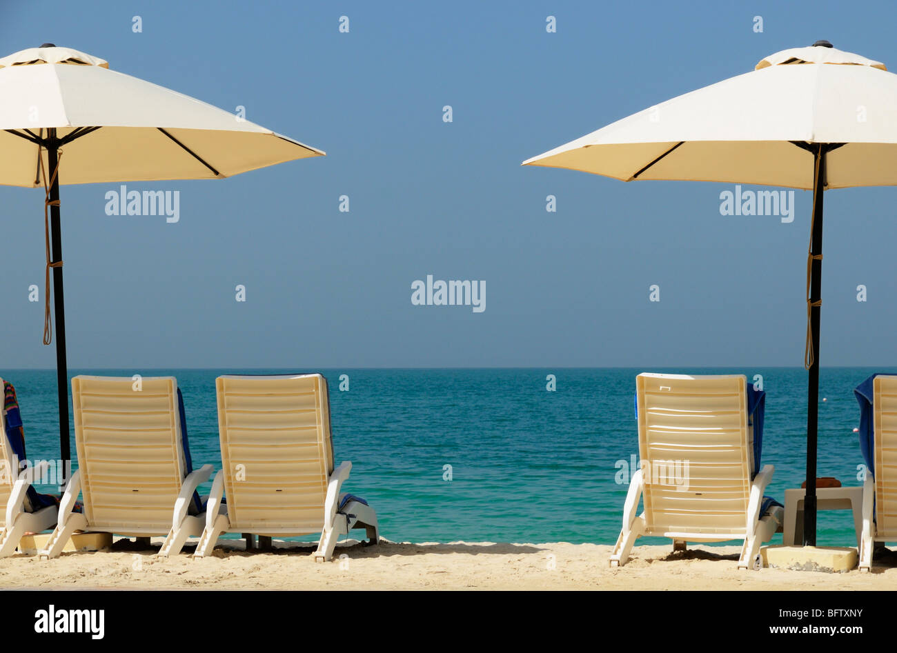 Private Hotel Beach and Parasols at the waterfront, Ras al Khaimah, UAE Stock Photo