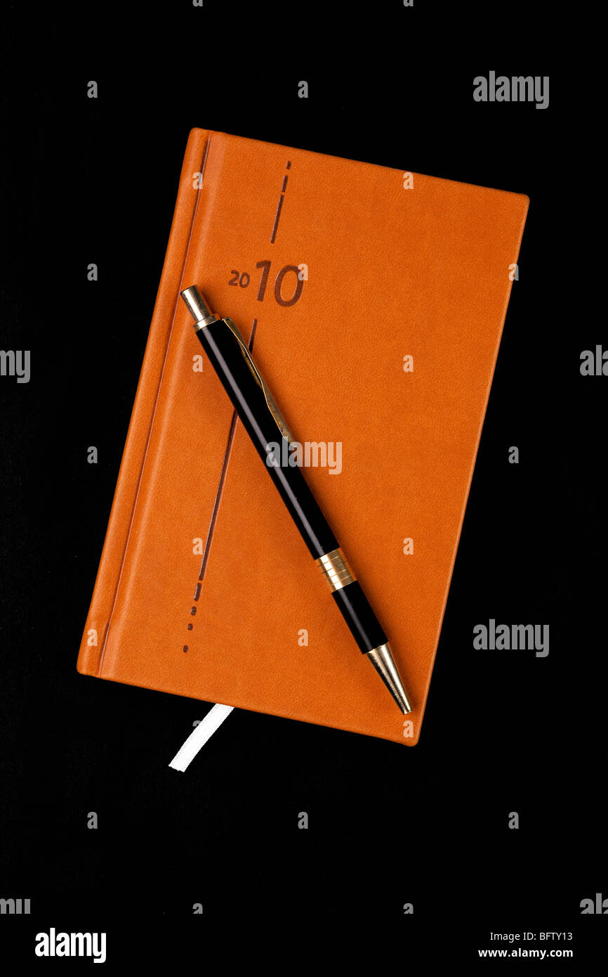 the brown diary and pen Stock Photo