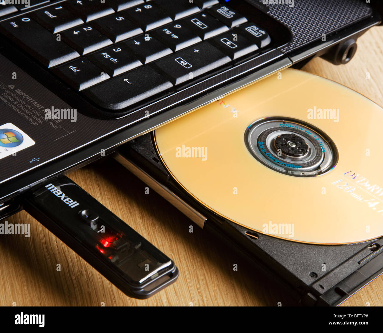 Compact disk in the drive and usb stick in a laptop computer Stock 