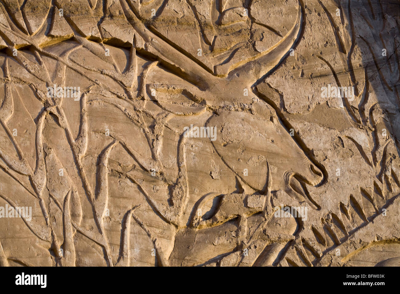 Close up of reliefs showing bull hunt at Medinet Habu , Mortuary Temple of Ramesses III, West bank of Nile, Luxor, Egypt Stock Photo