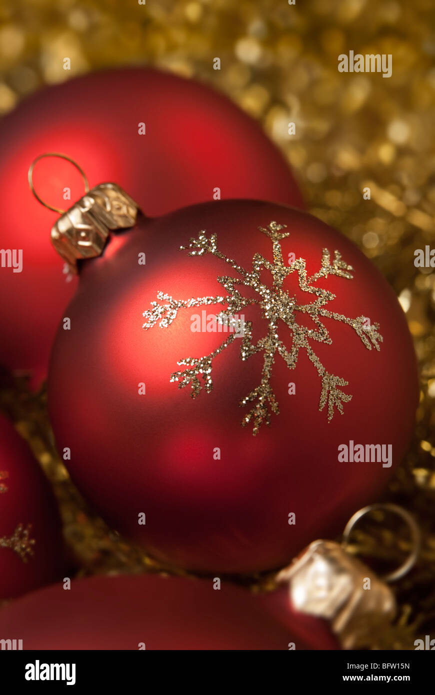 Red christmas ball on the gold tinsel. aRGB. Stock Photo