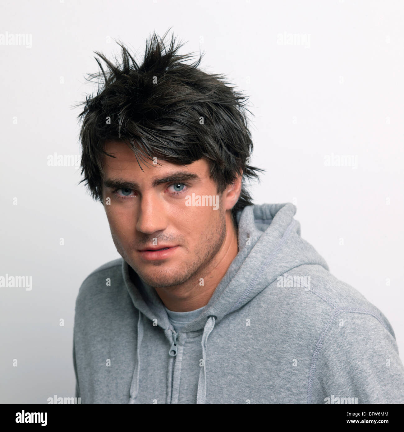 Young man in grey hooded top Stock Photo