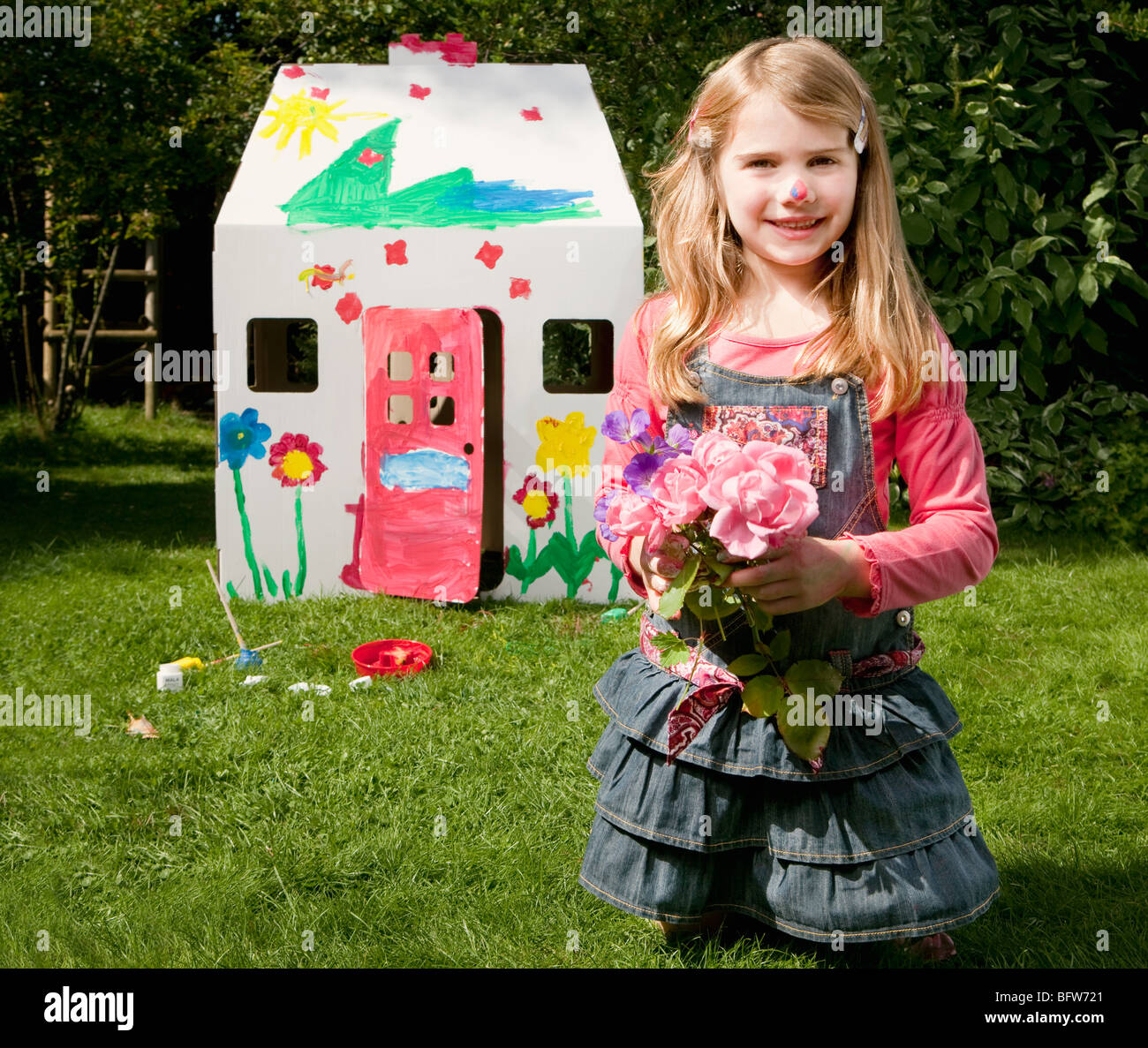 A girl with flowers and a wendy house Stock Photo Alamy