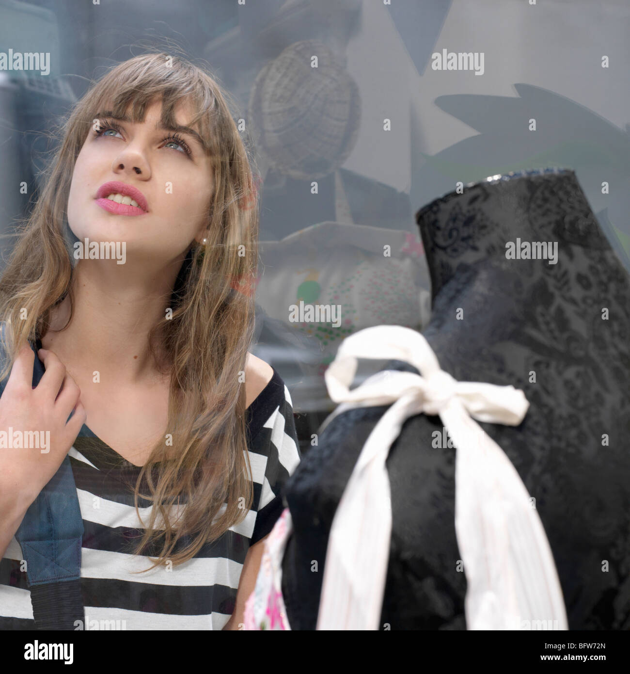Young woman looking at shop window Stock Photo