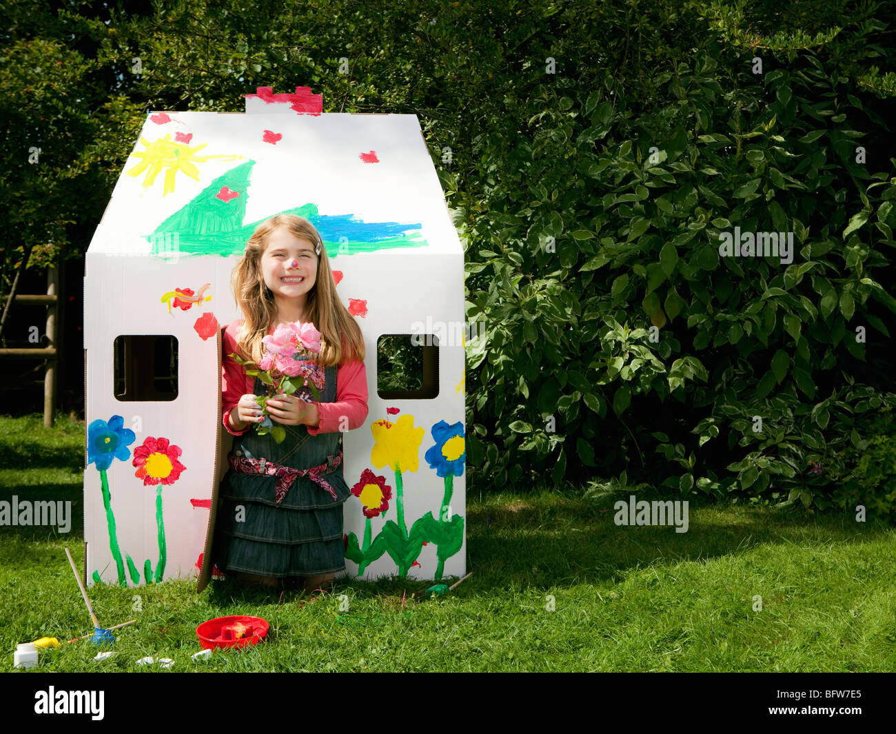 A girl with flowers and a wendy house Stock Photo Alamy