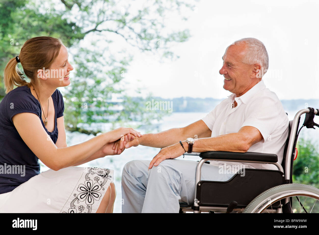 woman holding senior man's hand Stock Photo