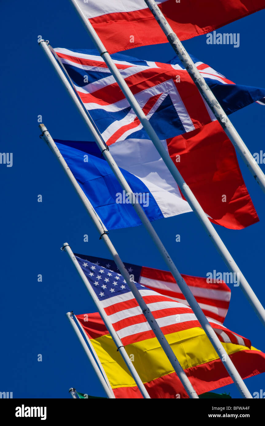 Close up of flags flag of the United Kingdom, United States of America, Spain and France with blue sky background Stock Photo