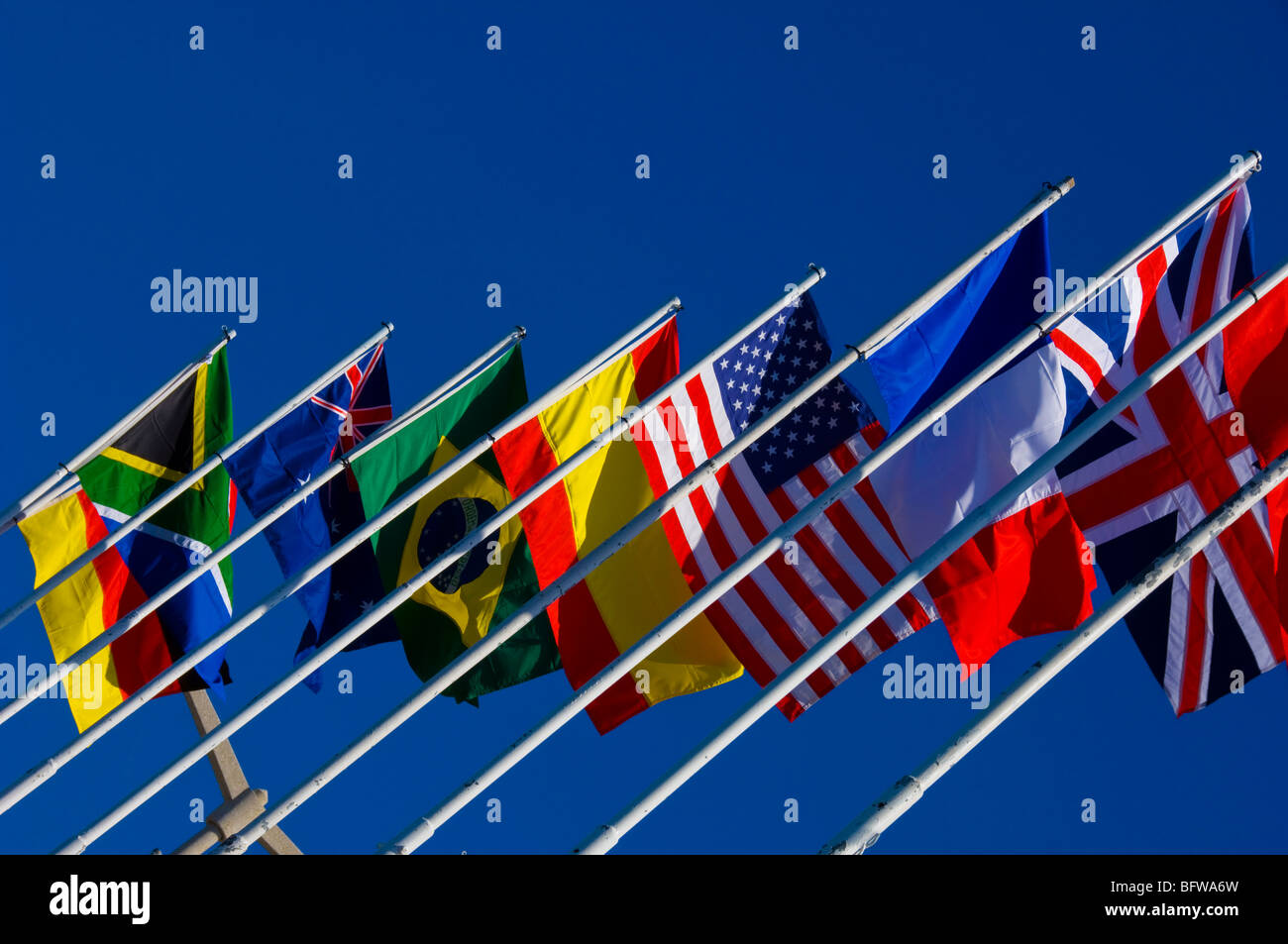 Close up of national flag flags of various countries against blue sky Stock Photo