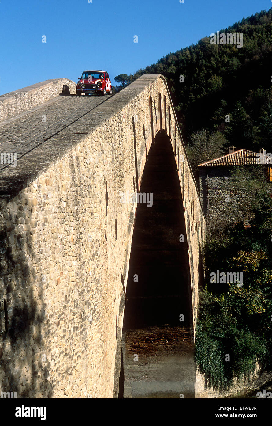 Mini rally car crossing a bridge in Ital 2003 Stock Photo