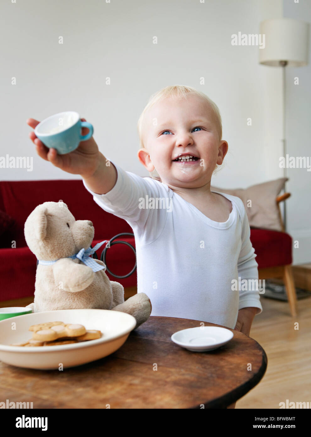 A boy toddler holding out a tea cup Stock Photo Alamy